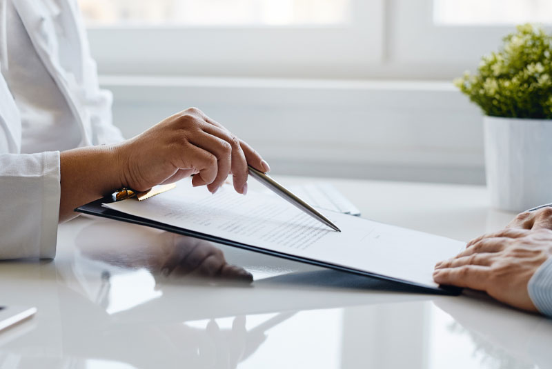 female dentist showing person paperwork